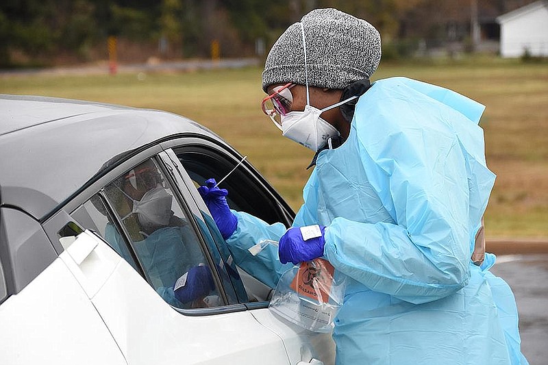 Breunna Lewis, a medical assistant for UAMS, administers a covid-19 test Thursday, Dec. 3, 2020 at the Lonoke Community Center. (Arkansas Democrat-Gazette/Staci Vandagriff)
