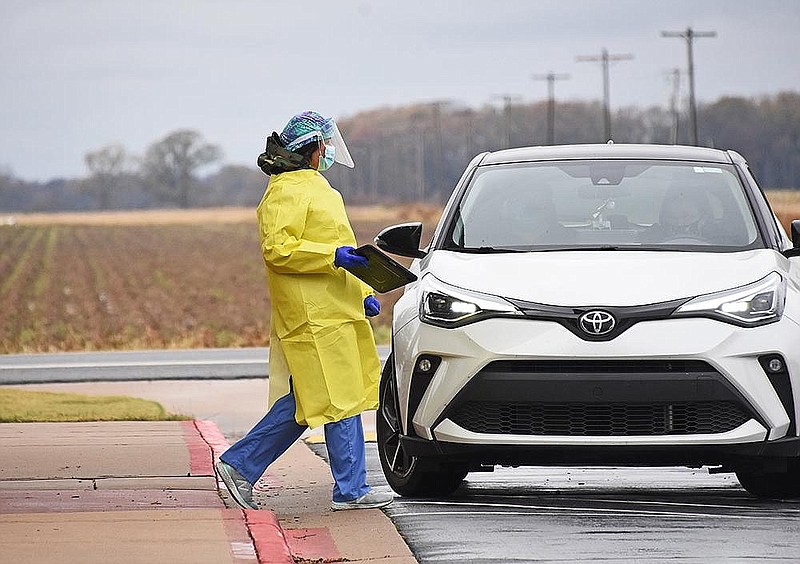 Barbara McDonald, an advanced practice registered nurse for UAMS, begins to screen patients Thursday, Dec. 3, 2020 during a drive-thru covid-19 testing at the Lonoke Community Center. (Arkansas Democrat-Gazette/Staci Vandagriff)
