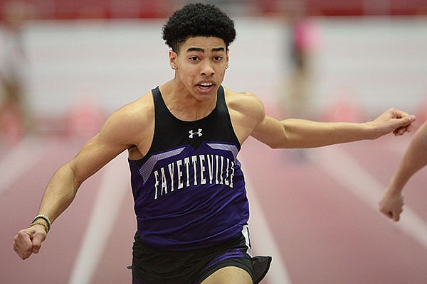 Isaiah Sategna of Fayetteville leans in at the finish Saturday, Feb. 29, 2020, of the 60 meters during the 5A/6A State Indoor Track and Field Championships in the Randal Tyson Track Center in Fayetteville. 