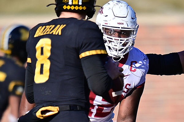Arkansas defensive lineman Jonathan Marshall (42) pressures Missouri quarterback Connor Bazelak during a game Saturday, Dec. 5, 2020, in Columbia, Mo. Marshall was Arkansas' only team captain available by the end of the game. 
