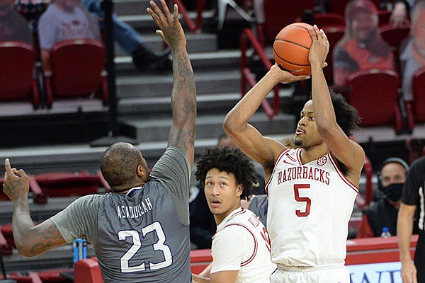 Arkansas guard Moses Moody (5) takes a shot in the lane Saturday, Dec. 5, 2020, as Lipscomb center Ahsan Asadullah (23) defends during the first half of play in Bud Walton Arena.