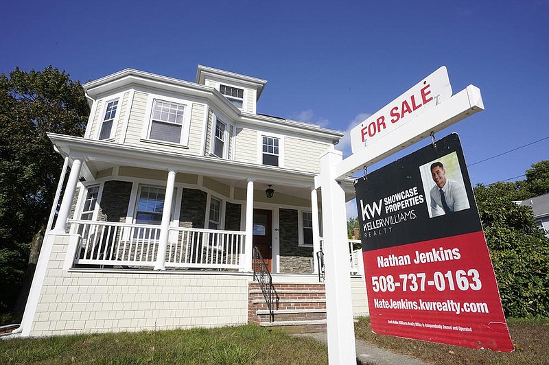 A for-sale sign stands in front of a house in Westwood, Mass., in October. The mortgage industry is in the middle of a boom because of the Federal Reserve’s low interest rates and bond purchases.
(AP/Steven Senne)