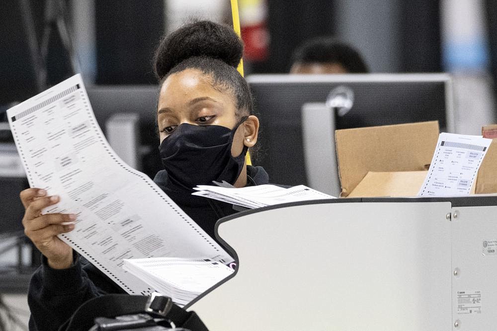 A worker scans ballots last month during the presidential recount in DeKalb County, Ga. The county on Friday recertified its vote, affirming Joe Biden’s victory.
(AP/Ben Gray)