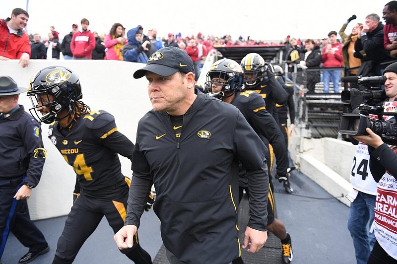 Barry Odom leads his players onto the field as Missouri’s head coach at War Memorial Stadium in Little Rock on Nov. 30, 2019. The Tigers defeated the Razorbacks, but Odom was fired the next day. Now Arkansas’ defensive coordinator, Odom faces his former team today in Columbia, Mo.
(AP file photo)