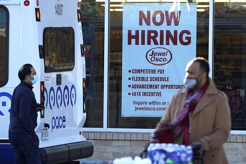 A sign on a grocery store in Deerfield, Ill., this week advertises for workers. U.S. employers added about 245,000 jobs in November as companies scaled back their hiring as the coronavirus pandemic accelerates across the country.
(AP/Nam Y. Huh)