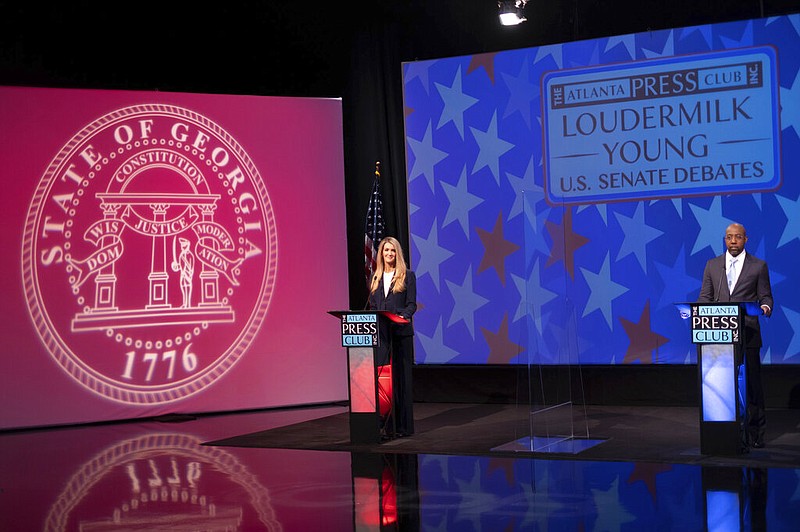 U.S. Sen. Kelly Loeffler (left), R-Ga., and Democratic challenger Raphael Warnock appear during a debate in Atlanta on Sunday, Dec. 6, 2020.