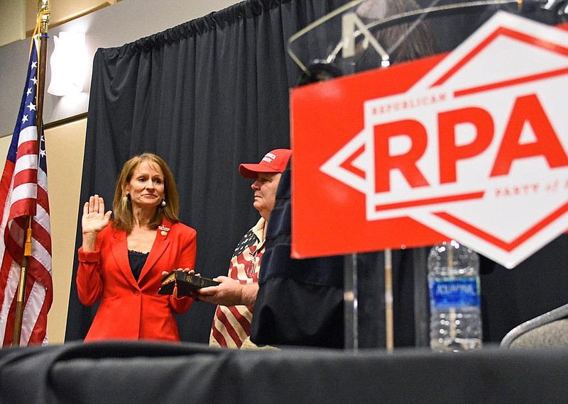 Jonelle Fulmer of Fort Smith is sworn in as the new chairwoman of the Republican Party of Arkansas as her husband, Dane Fulmer, watches Saturday, Dec. 5, 2020, at the Benton Event Center. More photos at arkansasonline.com/126rpa/.
