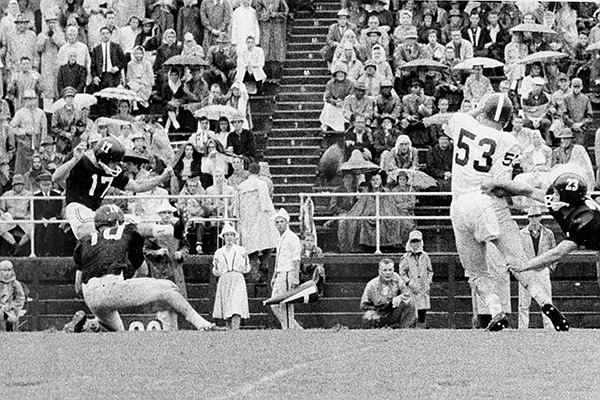 Fred Akers (left) kicks a 29-yard field goal during a game against TCU on Saturday, Oct. 3, 1959, in Fayetteville. 