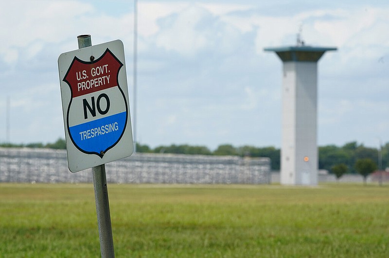 In this Aug. 28, 2020, file photo, a no trespassing sign is displayed outside the federal prison complex in Terre Haute, Ind.