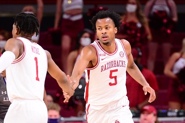 Arkansas guard Moses Moody (right) slaps hands with Razorbacks guard JD Notae during a game against Lipscomb on Dec. 5, 2020, in Bud Walton Arena in Fayetteville.