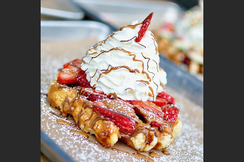 The House Waffle at Press Waffle Co. features strawberries, cookie butter, Nutella and house-made whipped cream. (Special to the Democrat-Gazette)