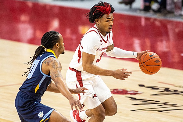 Arkansas guard Desi Sills (3) dribbles the ball while guarded by a Southern defender Wednesday, Dec. 9, 2020, in Fayetteville. 