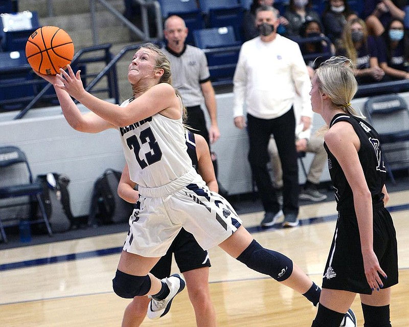 Greenwood's Kinley Fisher (23) goes to the basket between Fayetteville's Claudia Bridges (1) and Loren Lindsey (12) on Tuesday, Dec. 8, 2020, in H.B. Stewart Bulldog Arena in Greenwood. (Democrat Gazette/Brian Sanderford)