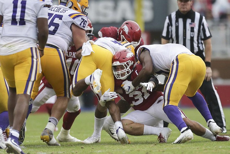 Arkansas linebacker Grant Morgan (31) tackles an LSU receiver, Saturday, November 21, 2020 during the third quarter of a football game at Donald W. Reynolds Razorback Stadium in Fayetteville. Check out nwaonline.com/201122Daily/ for today's photo gallery. 
(NWA Democrat-Gazette/Charlie Kaijo)