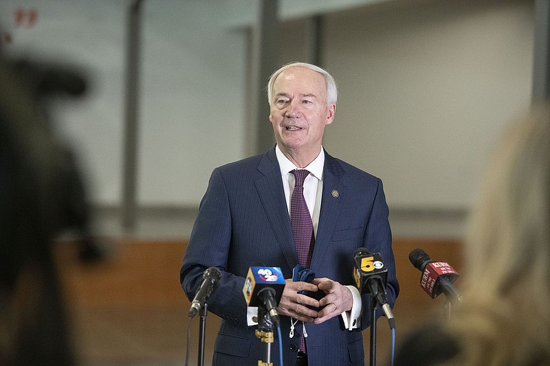 Gov. Asa Hutchinson takes questions Wednesday after a closed meeting with community leaders in Springdale.
(NWA Democrat-Gazette/J.T. Wampler)