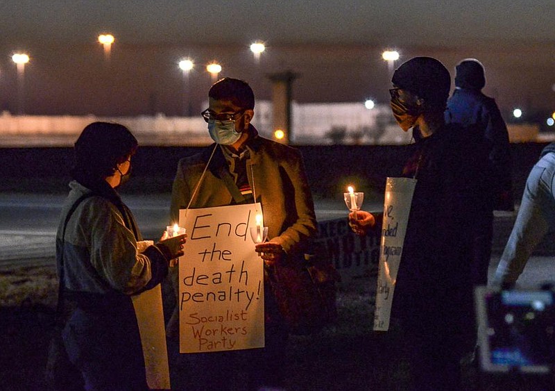 Gabby Prosser (left) and Nick Neeser (right) from Minneapolis talk with Samir Hazboun from Louisville, Ky., during a protest Thursday against the execution of Brandon Bernard in Terre Haute, Ind.
(AP/The Tribune-Star/Austen Leake) 