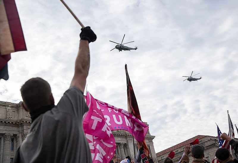 President Donald Trump, aboard Marine One, flies above supporters as they gather during a rally at Freedom Plaza in Washington on Saturday, Dec. 12, 2020. Supporters of the president gathered in Washington to protest what they falsely claim was a stolen election. (Victor J. Blue/The New York Times)