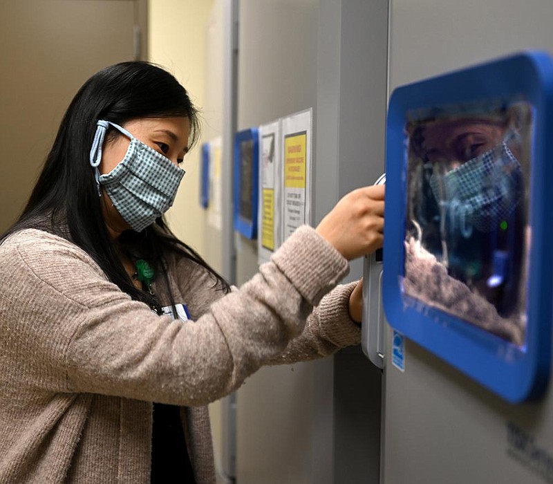 Hyejin Son, Director of Pharmacy at Baptist Health, opens one of the three new refrigerators that will be used to store doses of the coronavirus vaccine on Friday, Dec. 11, 2020.

(Arkansas Democrat-Gazette/Stephen Swofford)