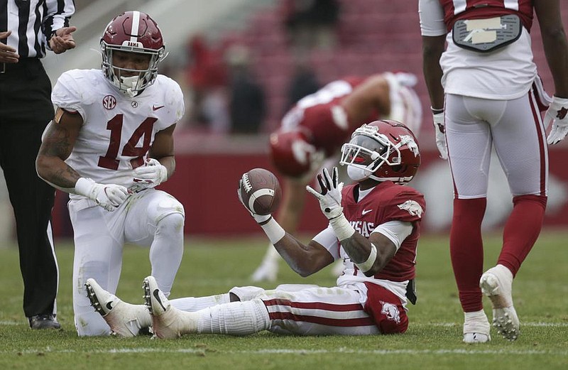 Arkansas wide receiver T.J. Hammonds (41) reacts after Alabama defensive back Brian Branch (14) blocks his run, Saturday, December 12, 2020 during the fourth quarter of a football game at Donald W. Reynolds Razorback Stadium in Fayetteville. Check out nwaonline.com/201213Daily/ for today's photo gallery. 
(NWA Democrat-Gazette/Charlie Kaijo)