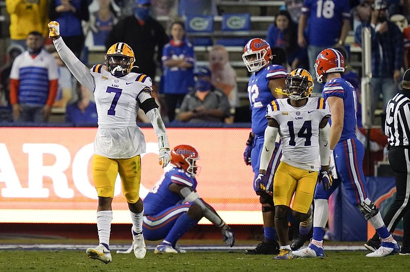 LSU safety JaCoby Stevens (7) and safety Maurice Hampton Jr. (14) celebrate after LSU stopped Florida on a fourth-and-goal at the 1-yard line during the first half of an NCAA college football game Saturday, Dec. 12, 2020, in Gainesville, Fla. (AP Photo/John Raoux)