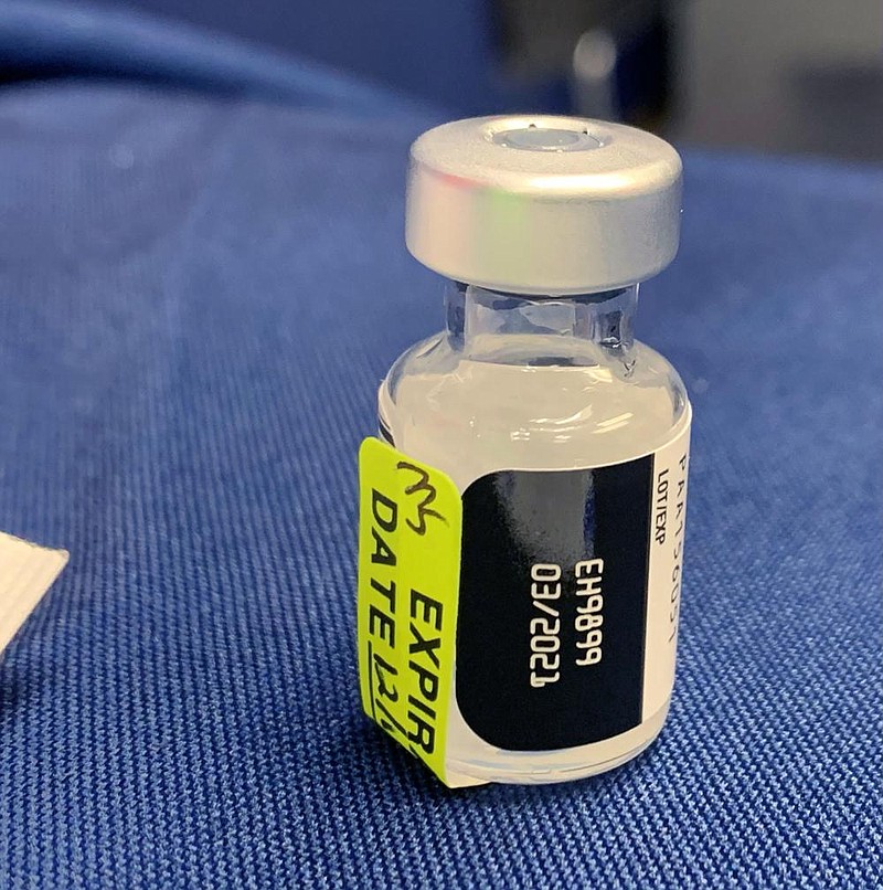 A vial of covid-19 vaccine is used Tuesday, Dec. 15, 2020, to vaccinate medical staff at the Northwest Health in Springdale. Frontline medical staff began receiving the vaccine. (NWA Democrat-Gazette/Andy Shupe)