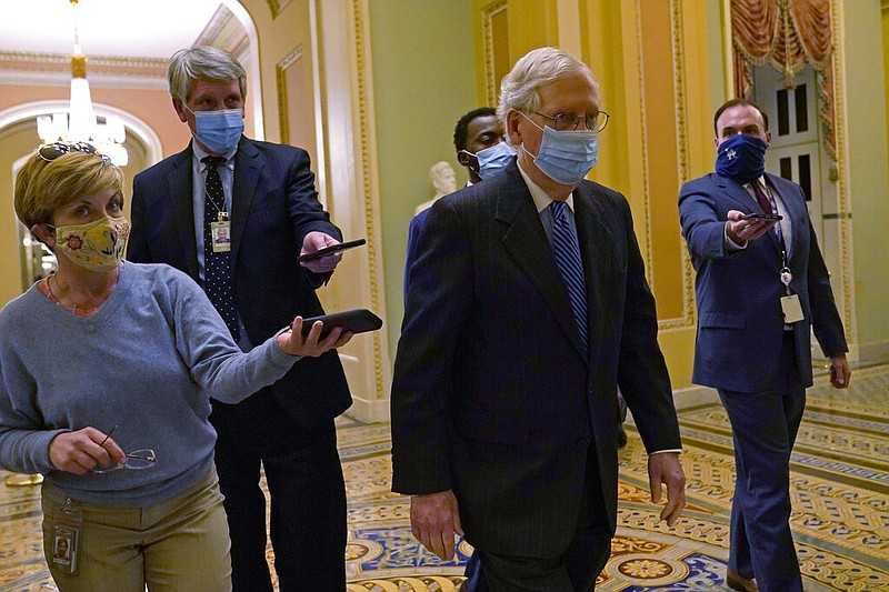 Senate Majority Leader Mitch McConnell of Ky., walks past reporters on Capitol Hill in Washington, Tuesday, Dec. 15, 2020.