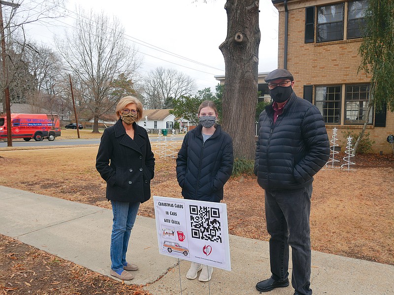 First United Methodist Church of Conway is hosting Christmas Cards in Cars With Cocoa, a virtual way of getting a holiday greeting from members of the church. Pictured, from left, are Pam Lentz, the director of children’s ministries; Olivia Cash, the children’s ministries intern; and Senior Pastor Michael Roberts. They are planting one of the signs used to access the videos in the yard of Emily Walter.