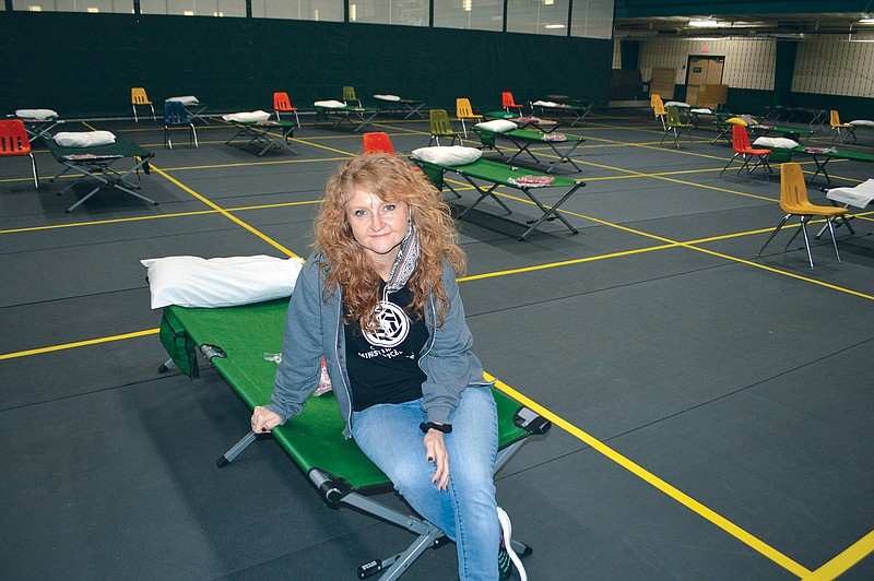 Spring Hunter sits on one of the cots available at the Conway Ministry Center’s winter warming station at the Conway Sports Center in the Don Owen Recreation Complex. The city offered the facility when the Ministry Center was desperate to find a location after its former building sold. City Council member Shelley Mehl said city officials believed “it was the right thing to do.”