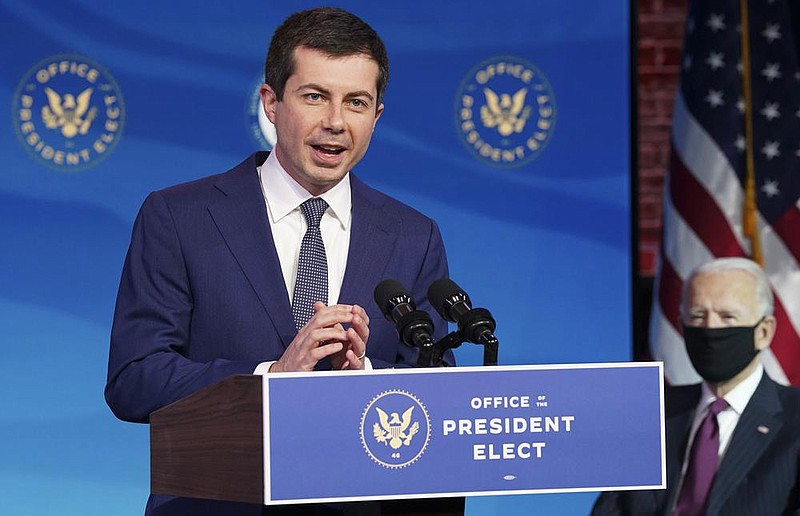 Pete Buttigieg speaks Wednesday in Wilmington, Del., after President-elect Joe Biden (background) nominated him to be transportation secretary. Biden said Buttigieg offers “a new voice with new ideas determined to move past old politics.”
(AP/Kevin Lamarque)