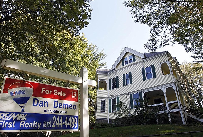 Mortgage rates for homes like this one in Newton, Mass., fell this week. The average rate on the 30-year fixed-rate home loan fell to 2.67% from 2.71% last week. A year ago, the benchmark rate was 3.73%.
(AP file photo)