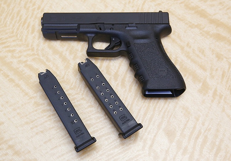 A handgun is displayed with a 10-shot magazine (left) and a 15-shot magazine (right) at a gun store in Elk Grove, Calif., in this June 27, 2017, file photo. (AP Photo/Rich Pedroncelli)
