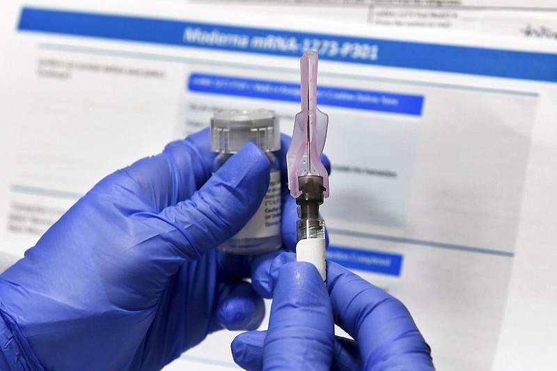 FILE - In this July 27, 2020, file photo, a nurse prepares a shot as a study of a possible COVID-19 vaccine, developed by the National Institutes of Health and Moderna Inc., gets underway in Binghamton, N.Y. The U.S. is poised to give the green light as early as Friday, Dec. 18, to a second COVID-19 vaccine, a critical new weapon against the surging coronavirus. Doses of the vaccine developed by Moderna Inc. and the National Institutes of Health will give a much-needed boost to supplies as the biggest vaccination effort in the nation’s history continues.