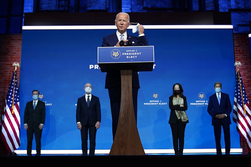 President-elect Joe Biden removes his face mask as he arrives to introduce his nominees and appointees to key national security and foreign policy posts at The Queen theater in Wilmington, Del., on Tuesday, Nov. 24, 2020.