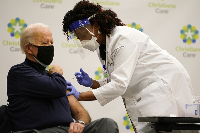 President-elect Joe Biden receives his first dose of the coronavirus vaccine at ChristianaCare Hospital in Newark, Del., Monday, Dec. 21, 2020, from nurse practitioner Tabe Mase. (AP Photo/Carolyn Kaster)

