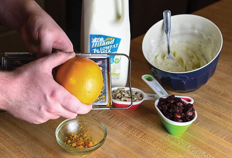 An orange is zested for the December installment of HER Around the Table.-Photo by Grace Brown of The Sentinel-Record