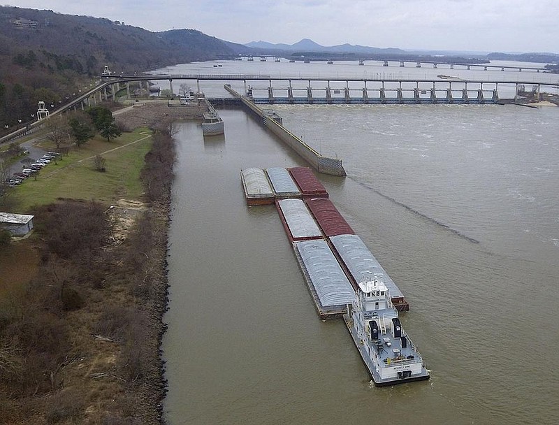 A barge makes its way up the Arkansas River into the lock at Murray Lock and Dam Monday March 2, 2020 in Little Rock. (Arkansas Democrat-Gazette/Staton Breidenthal)  

