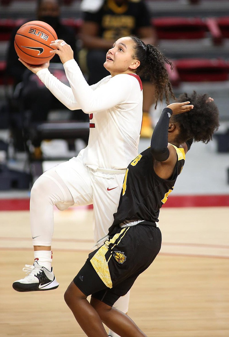 Destiny Slocum with the University of Arkansas Razorback Women's basketball team drives into the lane for a basket against Kaila Walker with the University of Arkansas at Pine Bluff Golden Lions December 21, 2020, at Bud Walton Arena on the campus of the University in Fayetteville. Check out nwaonline.com/201222Daily/ and nwadg.com/photos for a photo gallery.(NWA Democrat-Gazette/David Gottschalk)