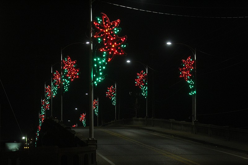 The Hillsboro Street viaduct is lit with the staple poinsettia flowers that illuminate the bridge and light poles throughout the city. (Matt Hutcheson/News-Times)