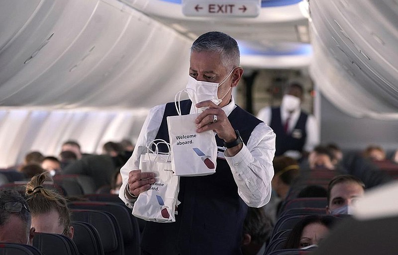 An American Airlines flight attendant hands out snack bags aboard a Boeing 737 Max jet before takeoff earlier this month at the Dallas/Fort Worth airport in Grapevine, Texas.
(AP/LM Otero)