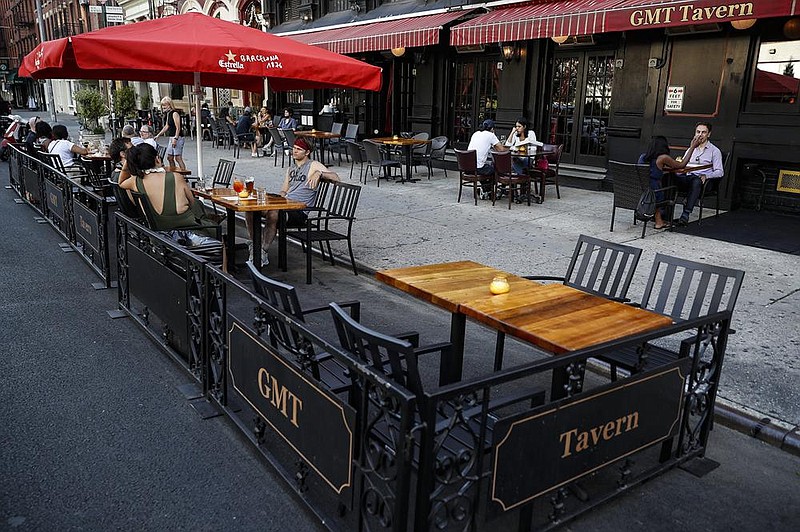 Customers dine outside GMT Tavern in New York in June. Included in the new emergency relief package is a provision to restore full tax breaks for restaurant business meals.
(AP)