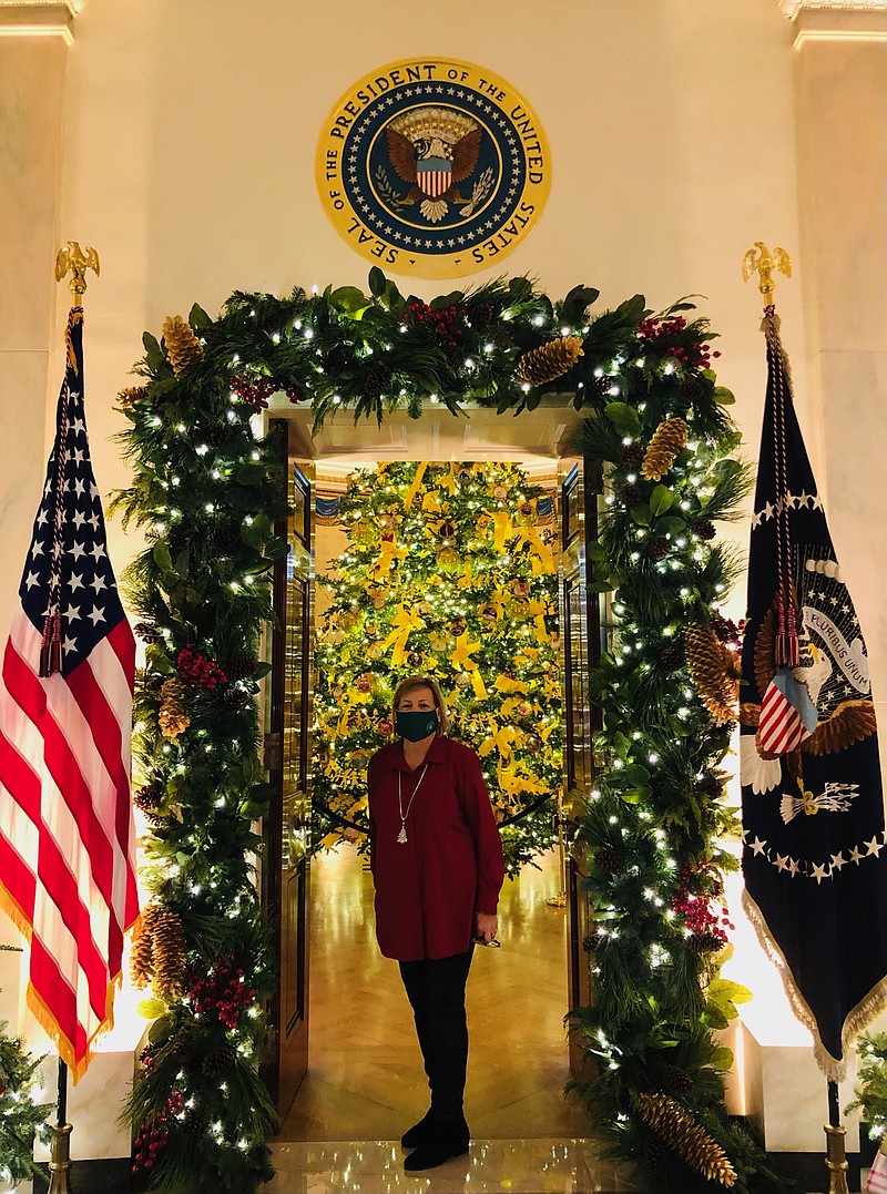 Liz Bullock of Magnolia stands under an archway in the White House where she was selected to decorate this year and last. (Contributed)