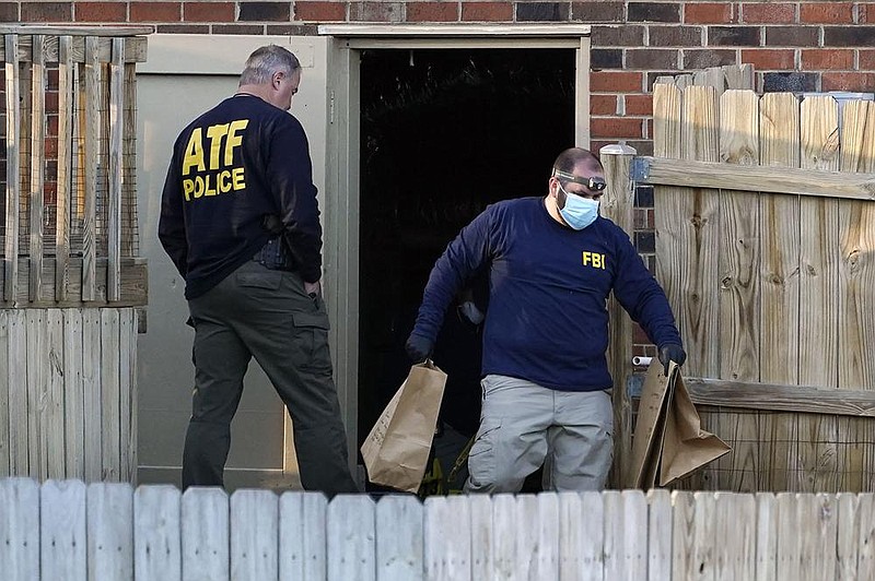 Investigators in the Nashville, Tenn., bombing case remove items from the basement of a home Saturday in that city. More photos at arkansasonline.com/1227nashville/.
(AP/Mark Humphrey)