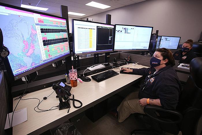 Call taker Brandi Johnson works in the MEMS call center working the TraumaCom and CovidCom system on Wednesday, Dec. 23, 2020, at the MEMS headquarters in Little Rock. 
(Arkansas Democrat-Gazette/Thomas Metthe)