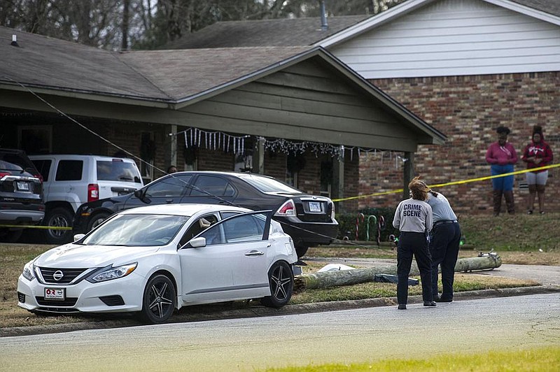 Officers investigate the scene of a homicide in the 8400 block of Labette Drive in Little Rock on Sunday. The homicide was one of four in a 24-hour period in Little Rock.