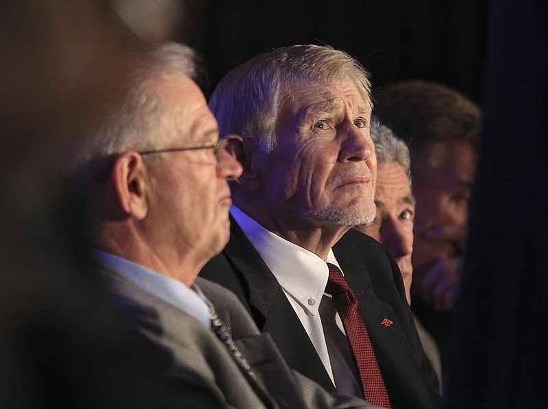  Arkansas Democrat-Gazette/STATON BREIDENTHAL --11/10/14--  Billy  Moore (left) and Loyd Phillips listen to the speakers Monday during the 2014 Southwest Conference Hall of Fame induction ceremony in Little Rock. 