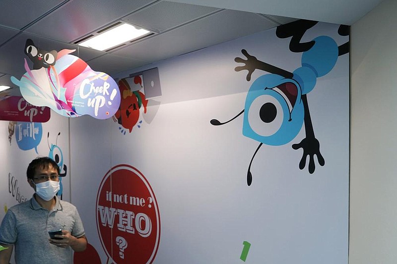An employee walks past the picture of Ant Group’s mascot at the Ant Group office in Hong Kong, in this October file photo.
(AP/Kin Cheung) story.lead_photo.caption