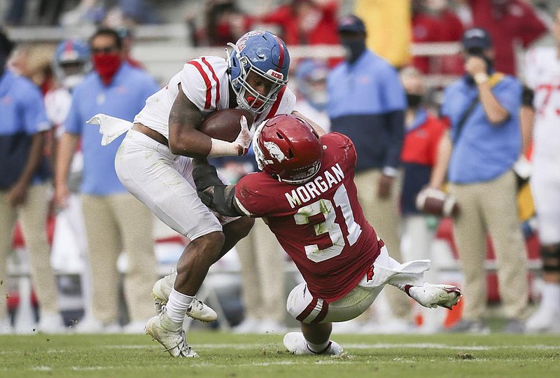 Arkansas linebacker Grant Morgan (31) tackles Ole Miss running back Jerrion Ealy (9), Saturday, October 17, 2020 during the second quarter of a football game at Donald W. Reynolds Razorback Stadium in Fayetteville. Check out nwaonline.com/201018Daily/ for today's photo gallery. 
(NWA Democrat-Gazette/Charlie Kaijo)

