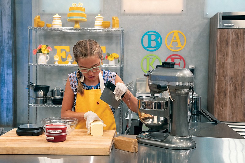 McKenzly Sandefer of Conway works at her station during an episode of “Kids Baking Championship” on the Food Network. The two-episode season premiere aired Dec. 28.