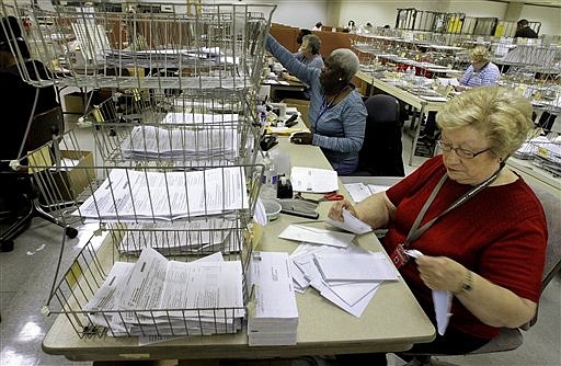 A worker processes income tax forms in this April 16, 2012, file photo.