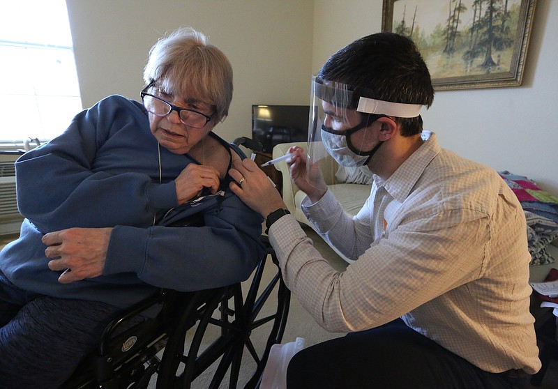 Pharmacist Daniel Cate with Market Place Pharmacy gives a covid-19 vaccine shot to resident Elizabeth Harthcock on Tuesday, Dec. 29, 2020, at Stonehaven Assisted Living Center in Maumelle.
(Arkansas Democrat-Gazette/Thomas Metthe)